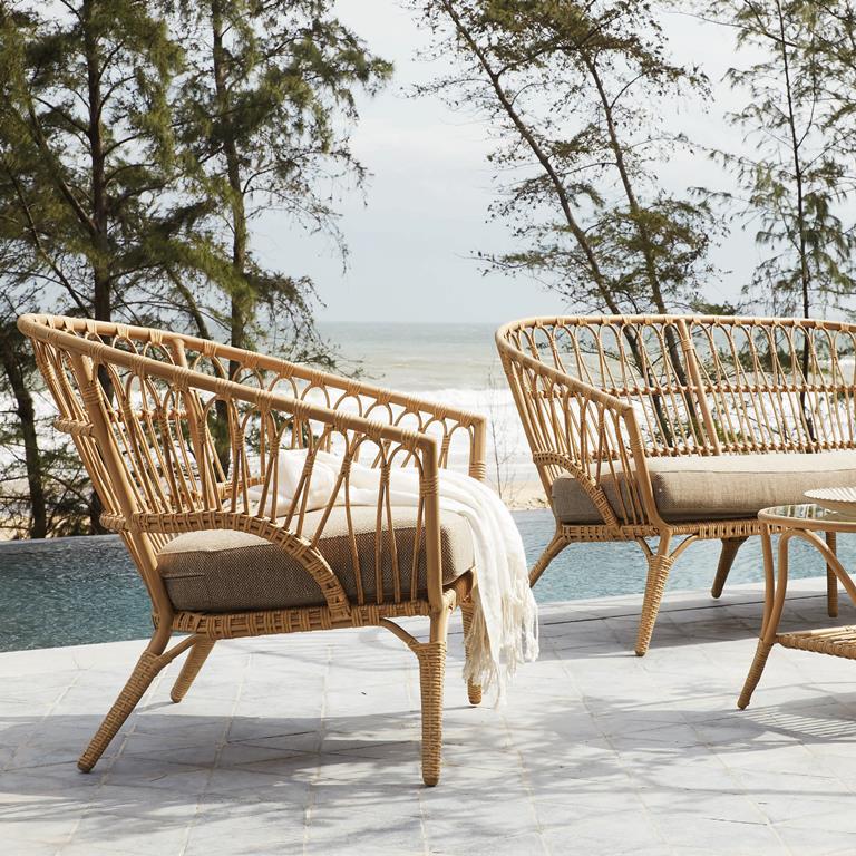 Rattan styled chair on the outdoors near a swimming pool