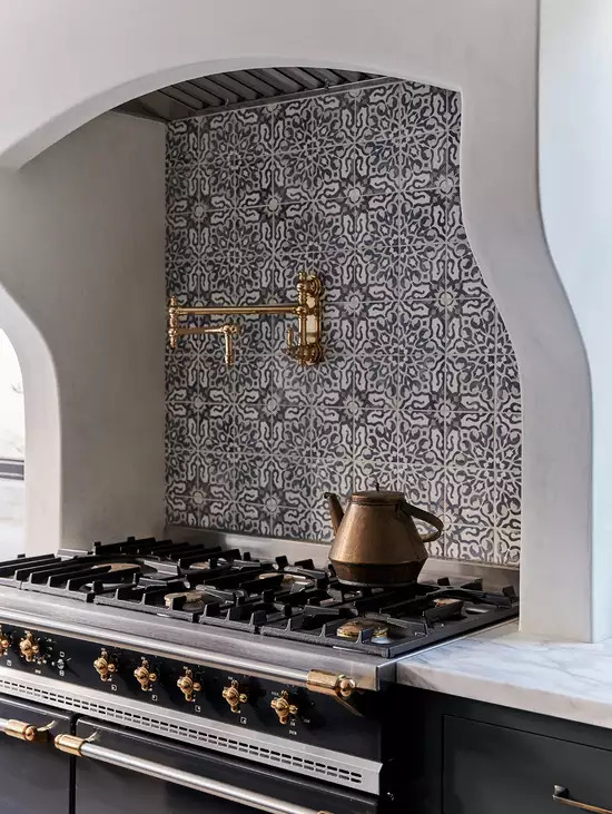 Patterned tiles on the back wall of stove