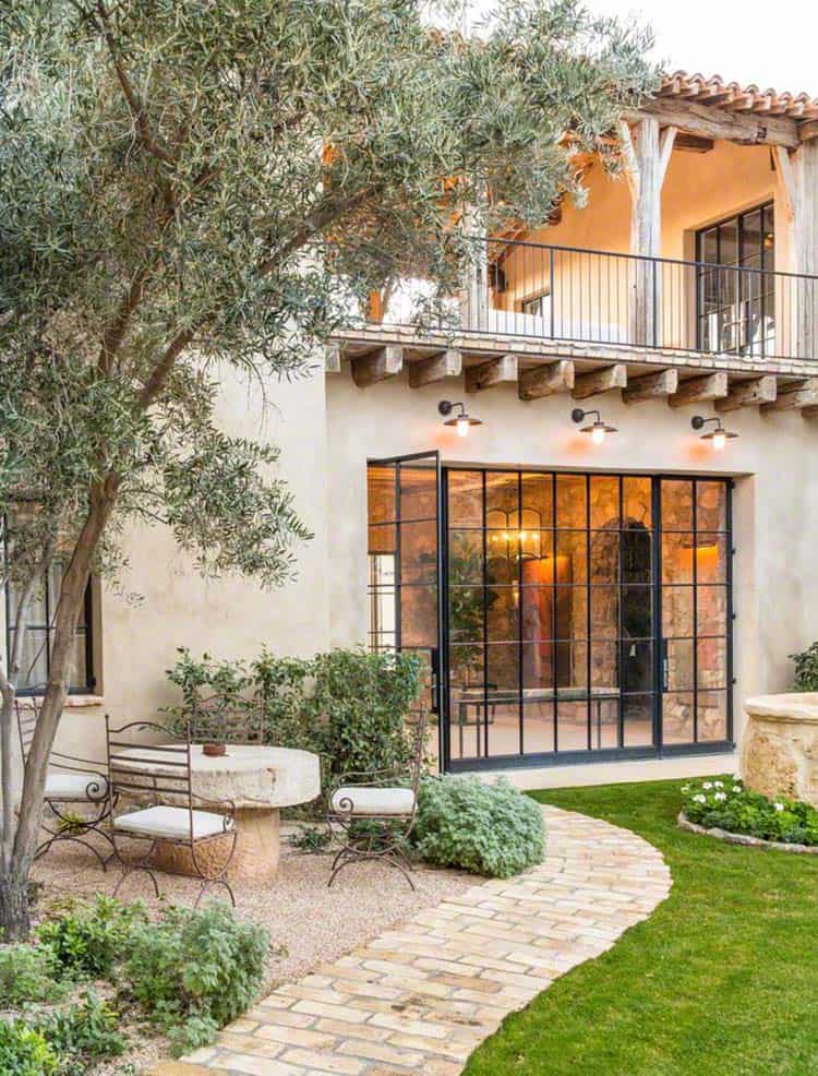 Mediterranean style home with an outdoor sitting, glass doors and rustic finish