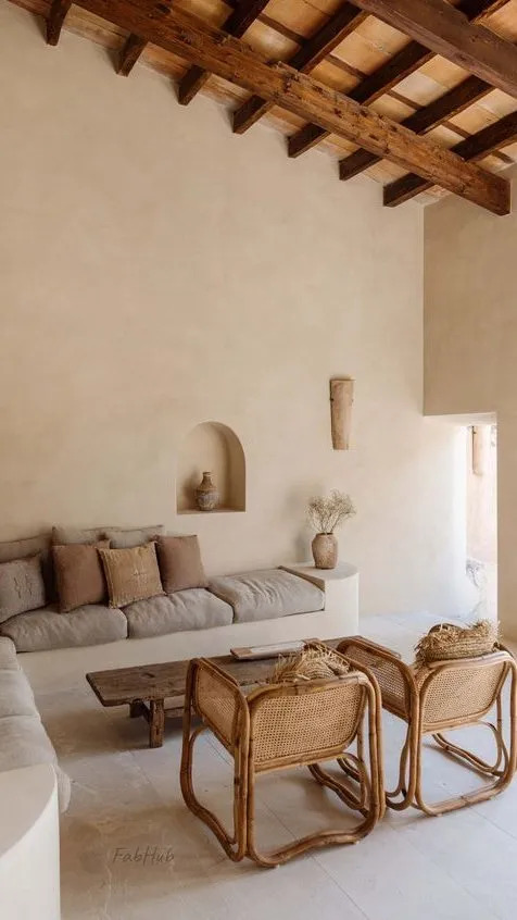 Mediterranean style living space with wooden beam on ceiling and rattan style chair with sofa
